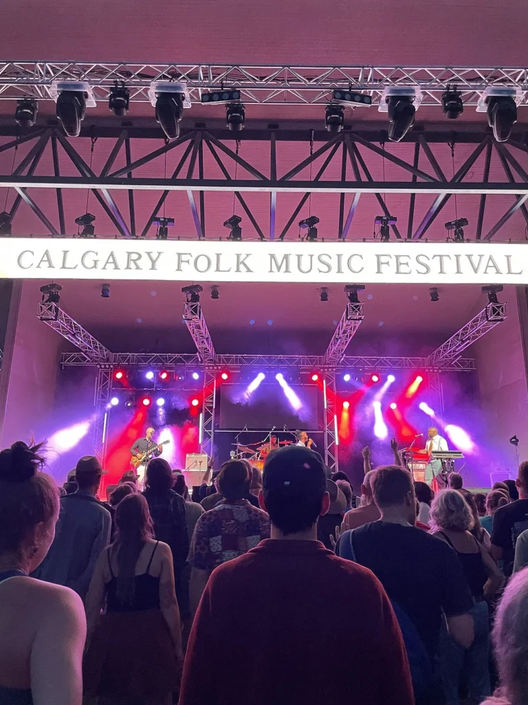 Festival audience gathered on the grass watching a main-stage concert