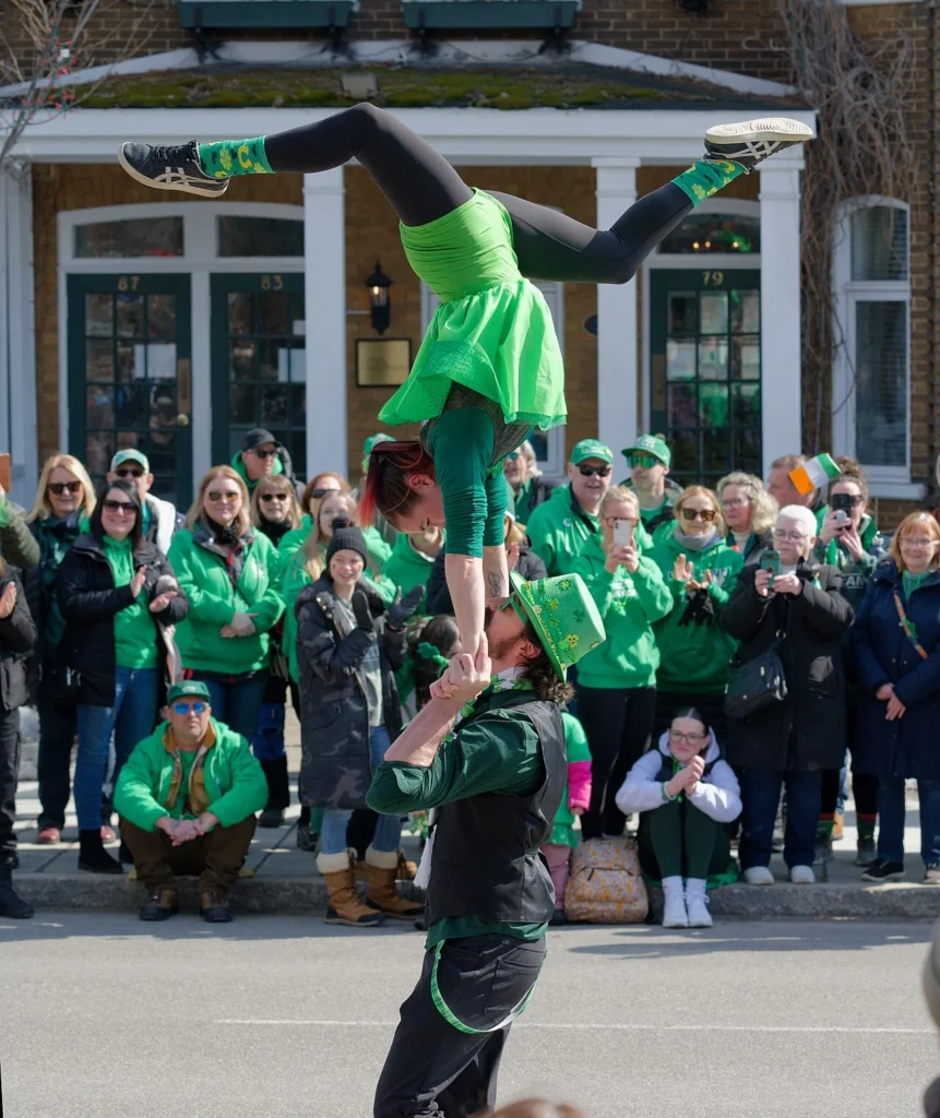 Acrobat performing for spectators at a St Patrick's Day parade