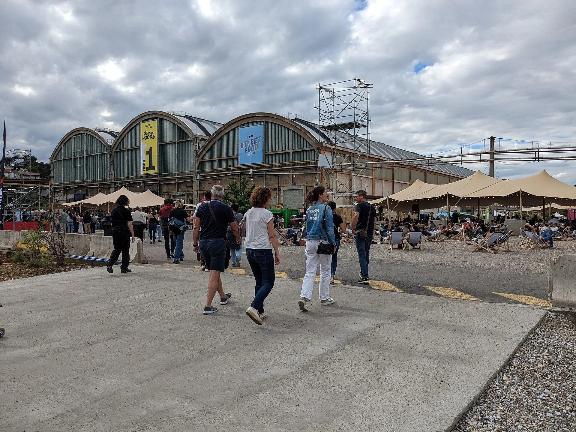 Visitors browsing food stalls at an outdoor street food festival