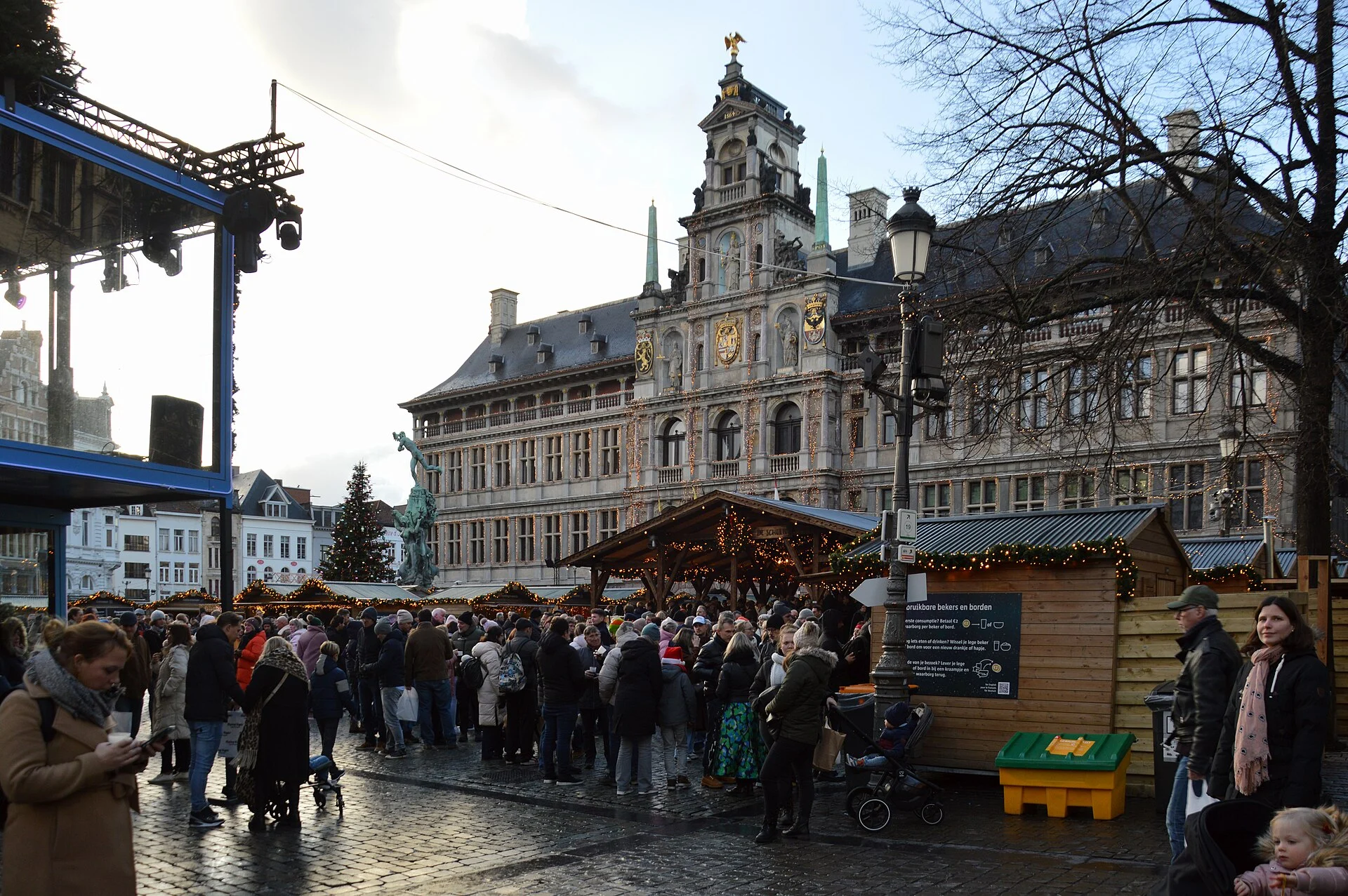 Christmas market stalls and festive lights in a historic town square